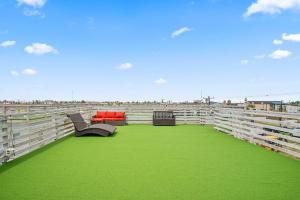 a arena with green grass and chairs in it at Above & Beyond in Port Aransas +20 photos