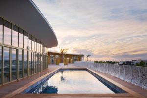 a view of a building with a swimming pool at Le Royal VIBES in Cap d'Agde