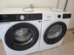 a white washer and dryer sitting next to each other at Studios Saint Mau 3 in Saint-Maurice-de-Gourdans +2 photos