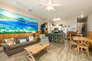 a living room with a couch and a table at Lets Padre at Village by the Beach in Padre Island