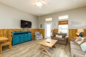 a living room with a couch and a table at Lets Padre at Village by the Beach in Padre Island