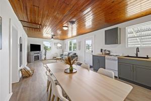 a kitchen and living room with a table and chairs at Whispering Oak- Lakefront Cabin Retreat in Madill