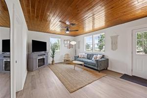 a living room with a couch and a tv at Whispering Oak- Lakefront Cabin Retreat in Madill