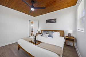 a bedroom with a bed and a ceiling fan at Whispering Oak- Lakefront Cabin Retreat in Madill