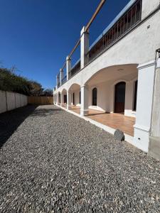 a large white building with a balcony on the side at Don Sánchez in Cafayate +5 photos
