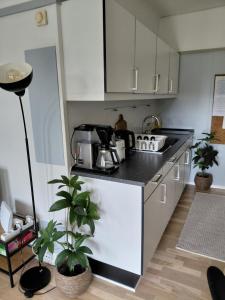 a kitchen with white cabinets and a black counter top at Antonia s quality apartment 1 in Viborg