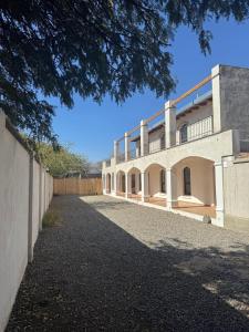 a large white building with a fence in front of it at Don Sánchez in Cafayate
