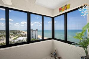 a room with windows with a view of the ocean at Oceanfront Penthouse 11b in Ormond Beach