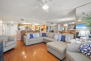 a living room with two couches and a couch at Oceanfront Penthouse 11b in Ormond Beach +35 photos