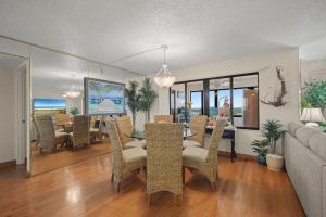 a living room with a dining table and chairs at Oceanfront Penthouse 11b in Ormond Beach