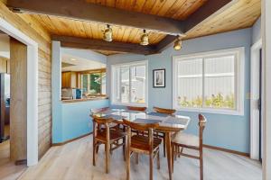 a dining room with blue walls and a wooden ceiling at Sea Side Cedar in Langley +22 photos