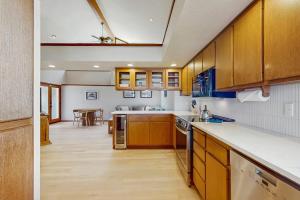 a large kitchen with wooden cabinets and a table at Sea Side Cedar in Langley