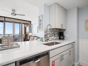 a kitchen with white cabinets and a sink at LR 309 - Ms, Annies Oasis in Rockport