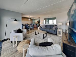 a living room with two couches and a table at Beachcomber 403 in Jacksonville Beach