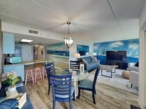 a kitchen and living room with a table and chairs at Beachcomber 403 in Jacksonville Beach +24 photos