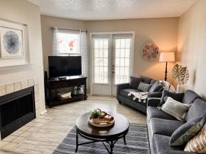 a living room with a couch and a fireplace at Toes In The Water II in Padre Island