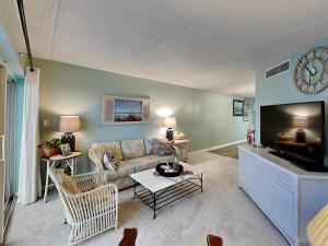 a living room with a couch and a flat screen tv at Jacksonville Beachdrifter 202 - Beach View in Jacksonville Beach