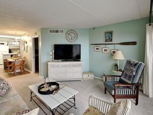 a living room with a flat screen tv on the wall at Jacksonville Beachdrifter 202 - Beach View in Jacksonville Beach