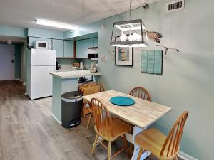 a kitchen and dining room with a table and chairs at Jacksonville Beachdrifter 202 - Beach View in Jacksonville Beach +27 photos