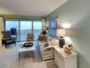 a living room with a couch and a table at Jacksonville Beachdrifter 202 - Beach View in Jacksonville Beach