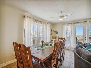 a dining room with a table and chairs and a couch at La Dolce Vita Playa San Luis in Galveston