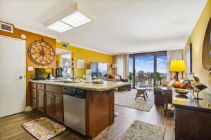 a kitchen with a large clock on the wall at San Luis Resort 533 - Luis Laid Back in Galveston
