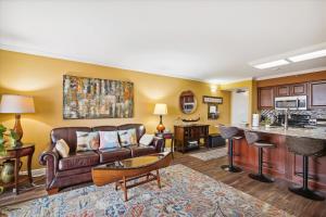 a living room with a couch and a table at San Luis Resort 533 - Luis Laid Back in Galveston