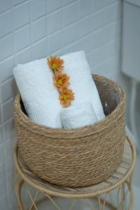 a basket of towels with flowers on top of it at Mansao in Maragogi +16 photos