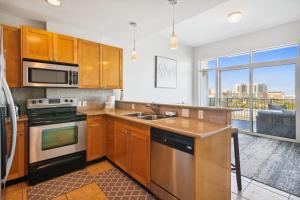 a kitchen with wooden cabinets and a large window at Emerald 705 in Galveston