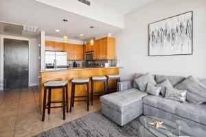 a living room with a couch and a kitchen at Emerald 705 in Galveston