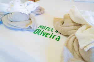 a table with towels and a sign that reads hotel aurelia at Hotel Oliveira in Goiânia +31 photos