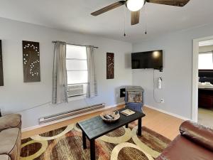 a living room with a coffee table and a fireplace at Knotty Pines Cabin in Ruidoso