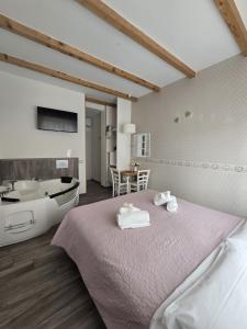 a bedroom with a bed and a tub and a sink at Il Mare Di Roma Luxury in Lido di Ostia