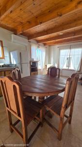 a wooden dining table and chairs in a kitchen at Aromas de Cafayate in Cafayate