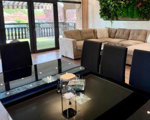 a living room with a table and a couch at Divna Pool&Garden  +27 photos