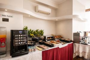 a buffet of food on a table in a kitchen at Hotel Vice-Rei in Porto