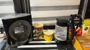 a kitchen counter with a coffee maker and a toaster at Divna Pool&Garden 
