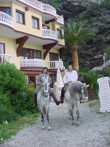 two people riding horses in front of a hotel at Castillo del Mar in Almuñécar
