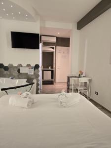 a bedroom with a large white bed with towels on it at Il Mare Di Roma Luxury in Lido di Ostia