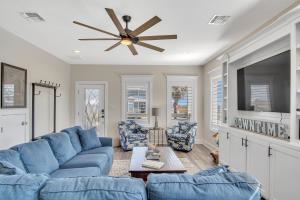 a living room with a blue couch and a tv at Downtime in Padre Island