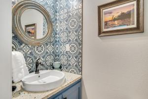 a bathroom with a sink and a mirror at Downtime in Padre Island +23 photos