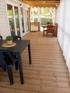 a porch with a table and chairs on a house at Feel MH 54 in Gastes