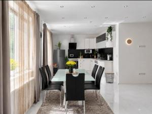 a dining room with a green table and black chairs at Deea Apartment in Schottwien