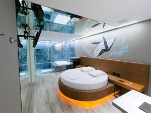 a bedroom with a bed and an aquarium at Motel Cavalo Branco in Belo Horizonte