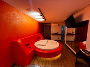 a red room with a bed in the middle of it at Motel Cavalo Branco in Belo Horizonte