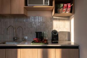 a kitchen counter with a coffee maker on it at Hyde Mexico City Reforma in Mexico City
