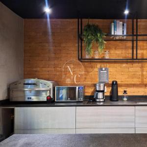 a kitchen with a counter top with a toaster and a toaster at RioDowntown Hub by RNC Flats in Rio de Janeiro