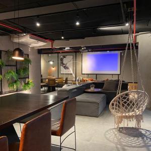 a living room with a couch and a tv at RioDowntown Hub by RNC Flats in Rio de Janeiro