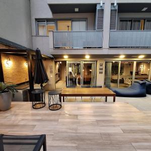 a patio with a wooden table and two stools at RioDowntown Hub by RNC Flats in Rio de Janeiro +278 photos