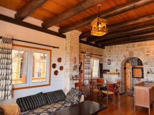 a living room with a couch and a table at Rahoni Park & Apartments in Dhërmi